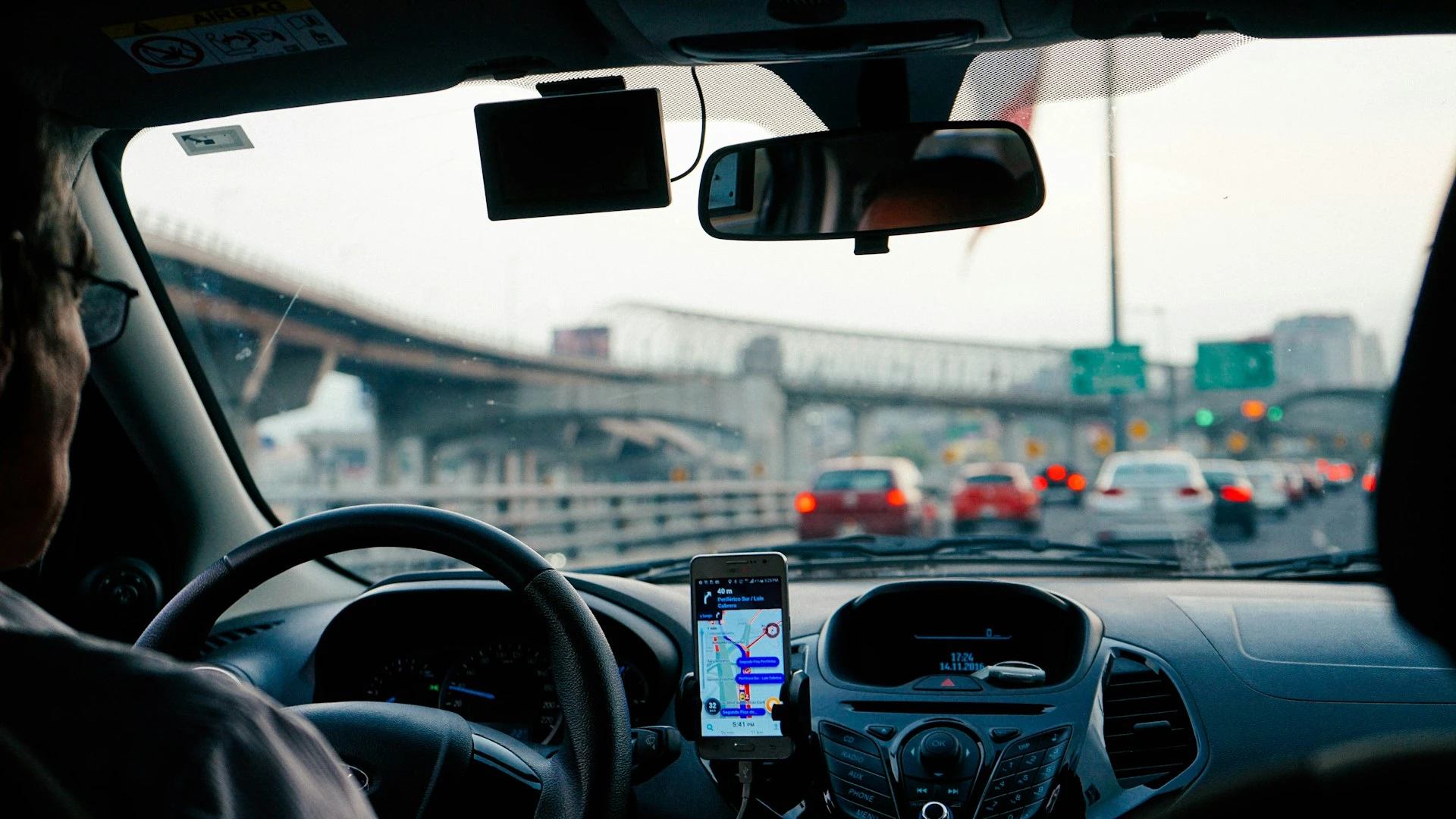 a high traffic airport road, image taken from the backseat